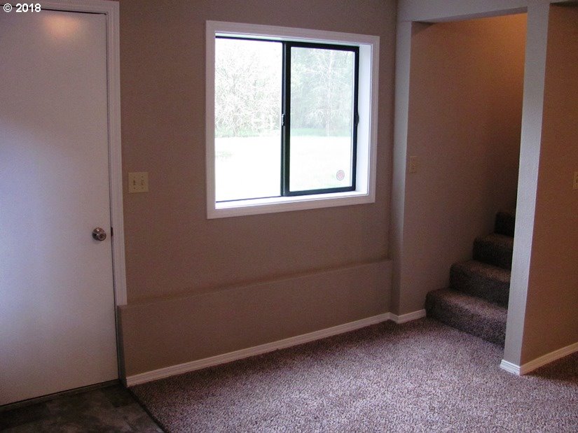 1940 Northeast 3rd Loop Camas, WA 98607 - Photo 11 of 22 an empty room with a chair and a window