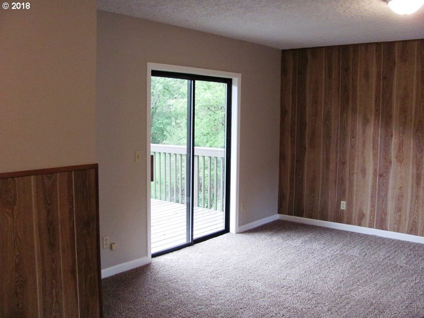 1940 Northeast 3rd Loop Camas, WA 98607 - Photo 4 of 22 a view of an empty room with wooden walls