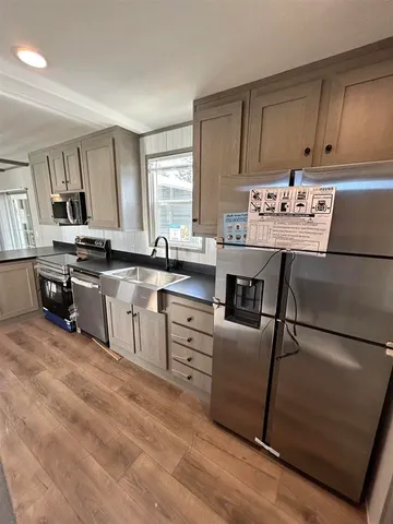 a kitchen with granite countertop a sink and cabinets