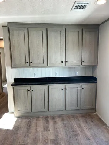 a view of an empty room with a fireplace and a window