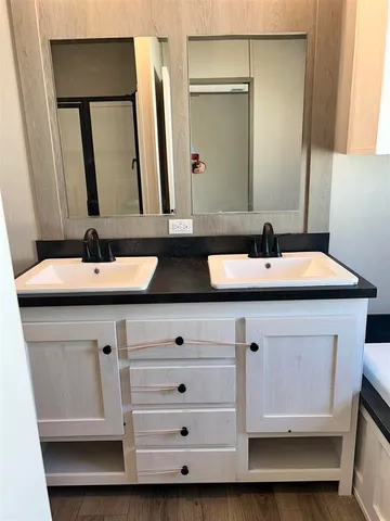 a kitchen with stainless steel appliances granite countertop a table chairs sink and cabinets