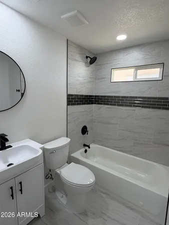 a bathroom with a toilet a sink and bathtub