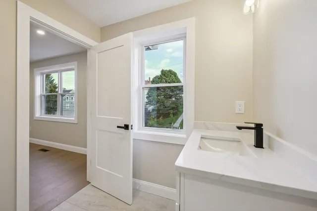 a bathroom with a sink and a window