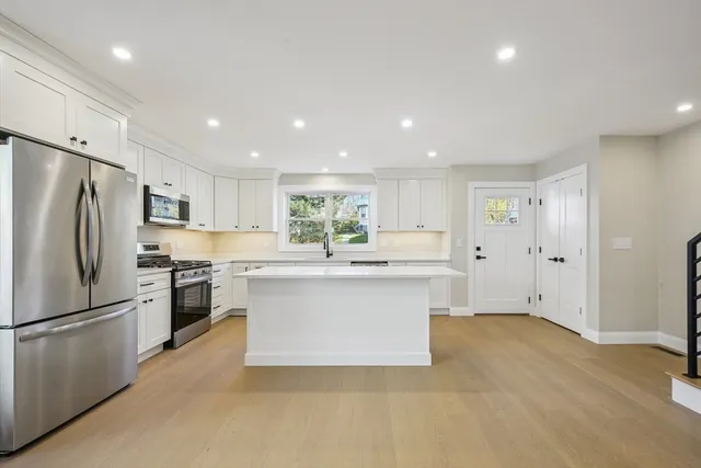 a kitchen with stainless steel appliances a refrigerator sink and cabinets