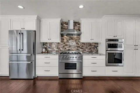 a kitchen with a table chairs stove and cabinets