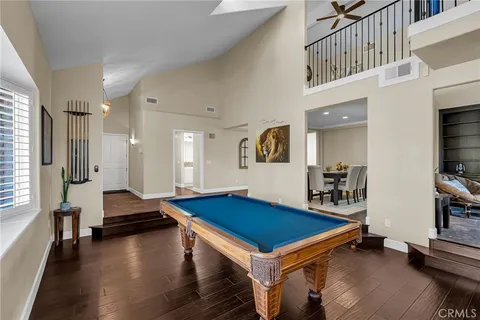 a view of a hallway to a livingroom with furniture and wooden floor