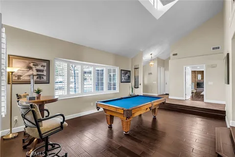 a bathroom with double vanity sinks a vanity a lamp and a mirror
