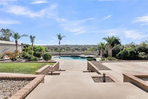 a view of a house with backyard and sitting area