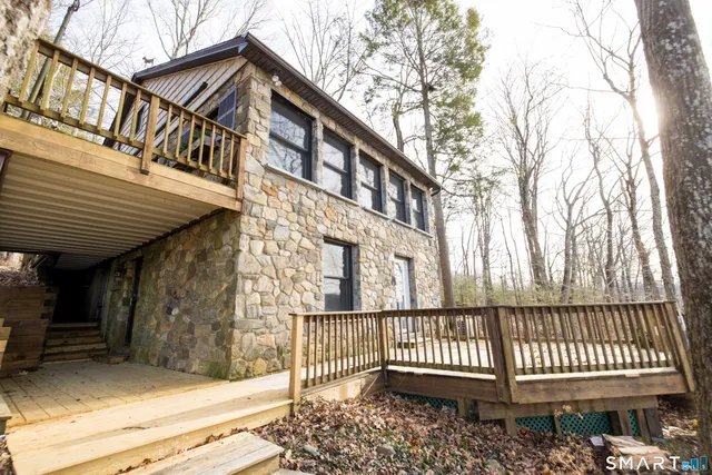a view of a house with a small deck