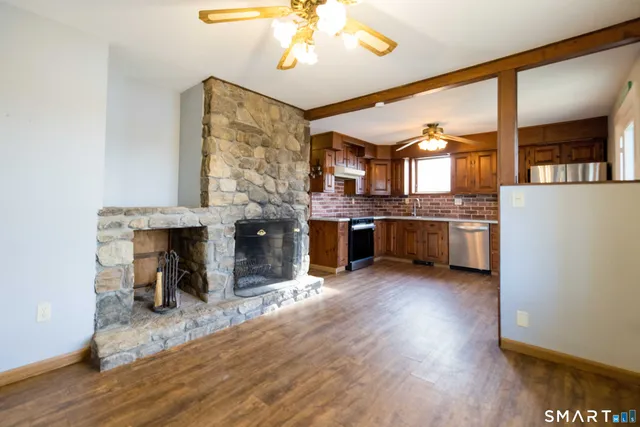 a view of open kitchen stove microwave and refrigerator