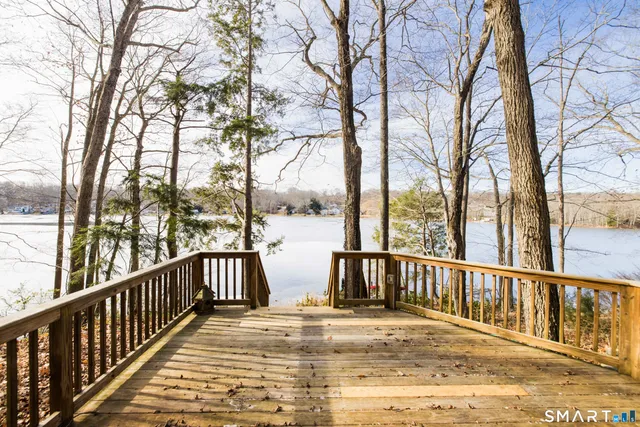 a view of a brick house with wooden fence