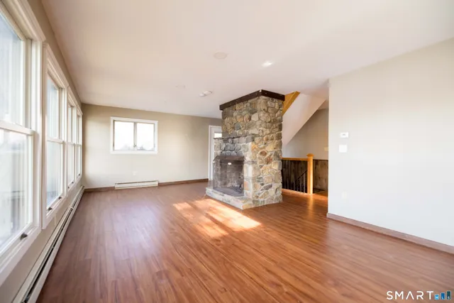 wooden floor in an empty room with a window