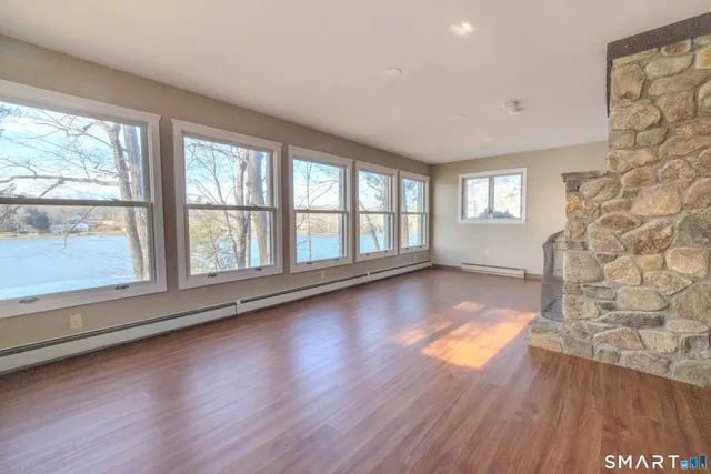 wooden floor in an empty room with a window