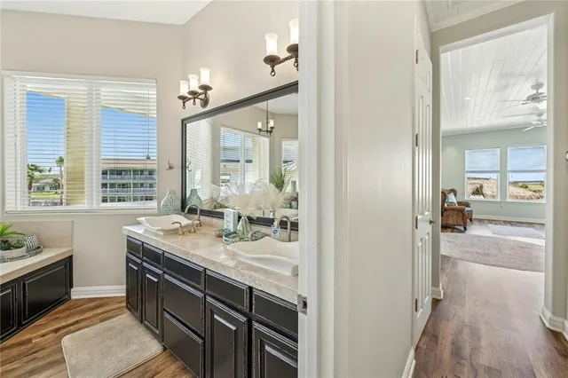 a bathroom with a granite countertop sink a mirror and a shower