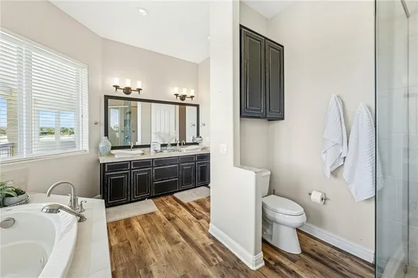 a bathroom with a sink a toilet and mirror