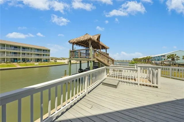 a view of a balcony with wooden floor and city view