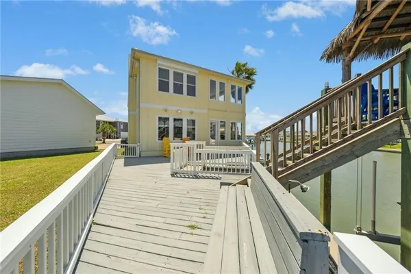 a view of balcony with wooden floor and fence