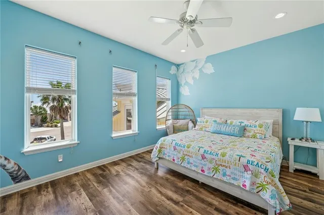 a bedroom with a bed next to a window