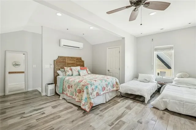 a bedroom with two beds and painting on the wall