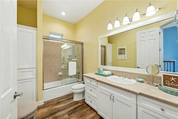 a spacious bathroom with a granite countertop sink mirror and toilet