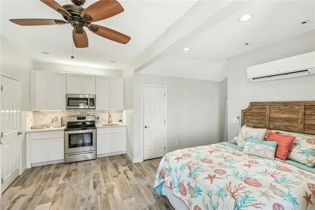 a bedroom with a bed and a chandelier