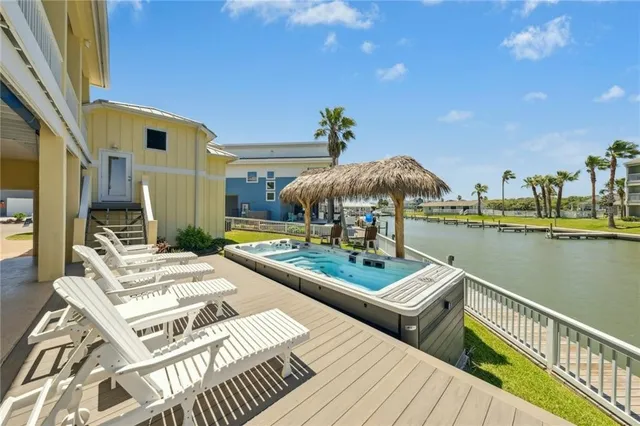 a view of a house with pool and chairs