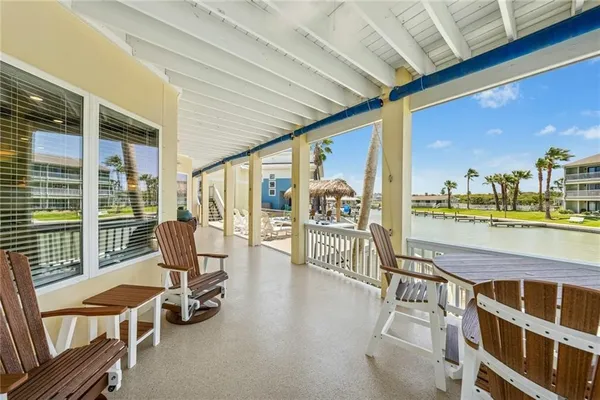 a view of a patio with swimming pool table and chairs