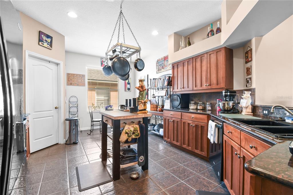 11130 Rodeo Lane Riverview, FL 33579 - Photo 11 of 49 a kitchen with stainless steel appliances granite countertop a sink a stove a refrigerator cabinets and chairs