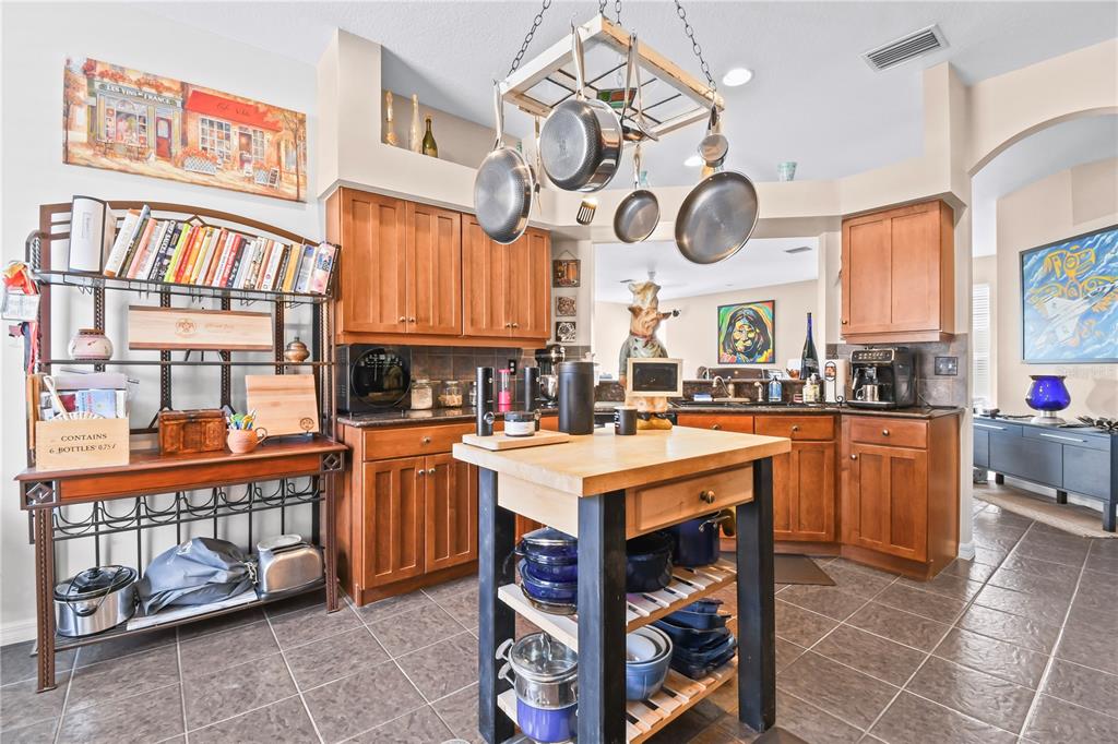 11130 Rodeo Lane Riverview, FL 33579 - Photo 13 of 49 a kitchen with stainless steel appliances granite countertop a stove and a wooden cabinets
