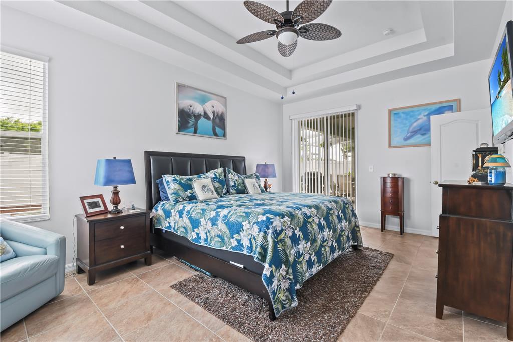 11130 Rodeo Lane Riverview, FL 33579 - Photo 17 of 49 a bedroom with a bed and a chandelier