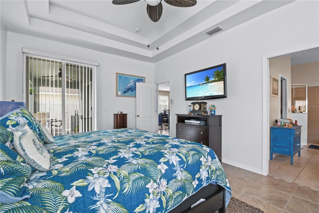 11130 Rodeo Lane Riverview, FL 33579 - Photo 18 of 49 a bedroom with a bed and a television