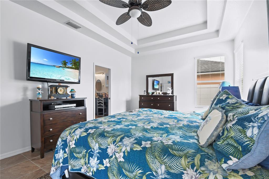 11130 Rodeo Lane Riverview, FL 33579 - Photo 19 of 49 a bedroom with a bed and a flat screen tv