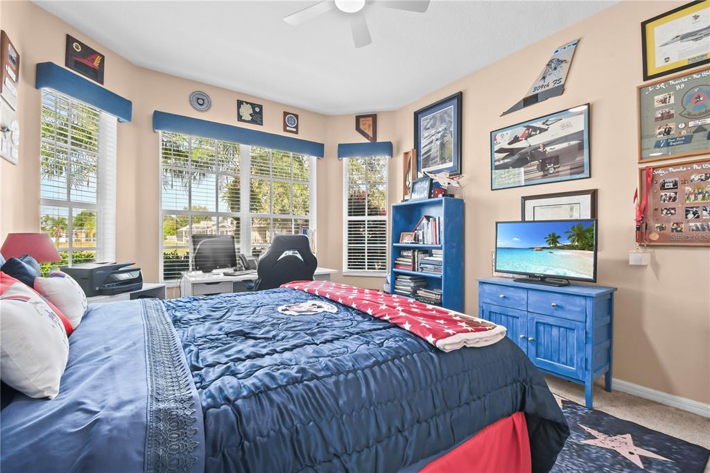 11130 Rodeo Lane Riverview, FL 33579 - Photo 32 of 49 a bedroom with a bed wooden floor and window