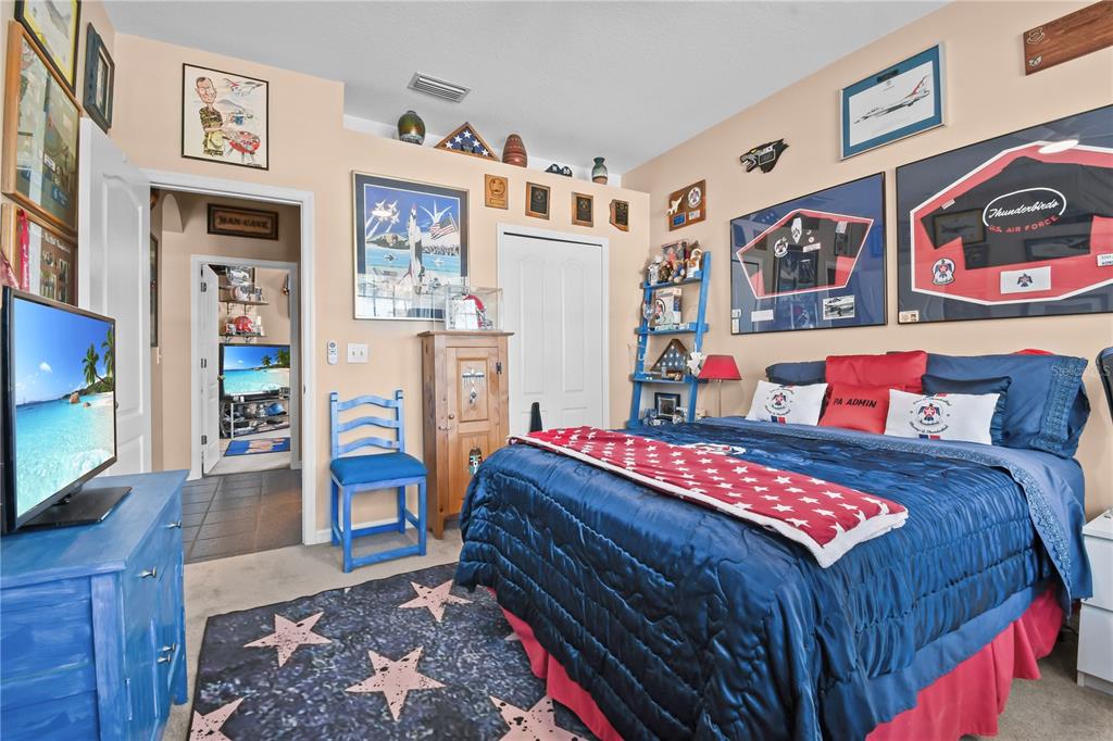 11130 Rodeo Lane Riverview, FL 33579 - Photo 33 of 49 a bedroom with a bed and a flat screen tv