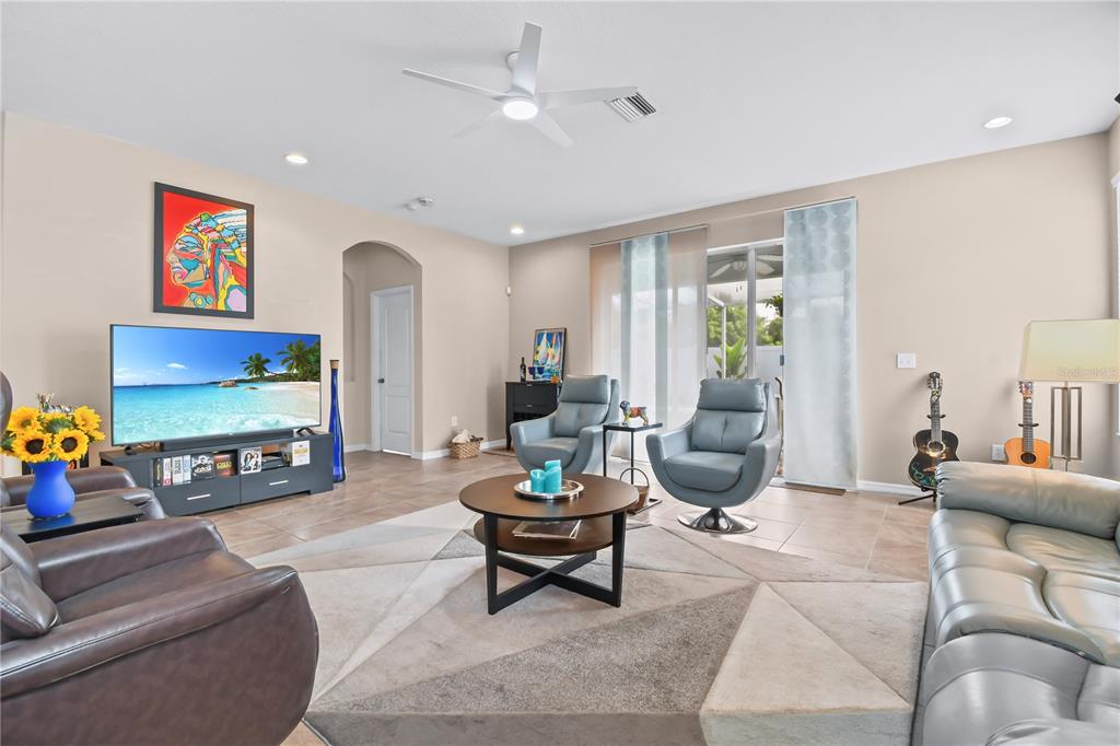 11130 Rodeo Lane Riverview, FL 33579 - Photo 6 of 49 a living room with furniture a rug and a flat screen tv