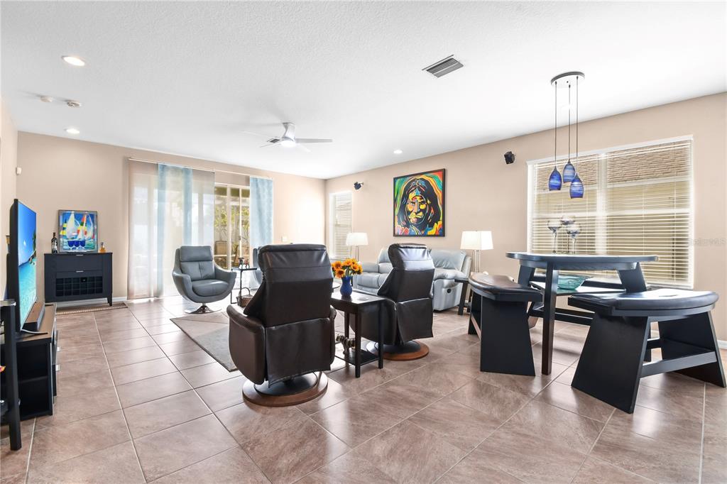 11130 Rodeo Lane Riverview, FL 33579 - Photo 7 of 49 a living room with furniture a large window and a dining table