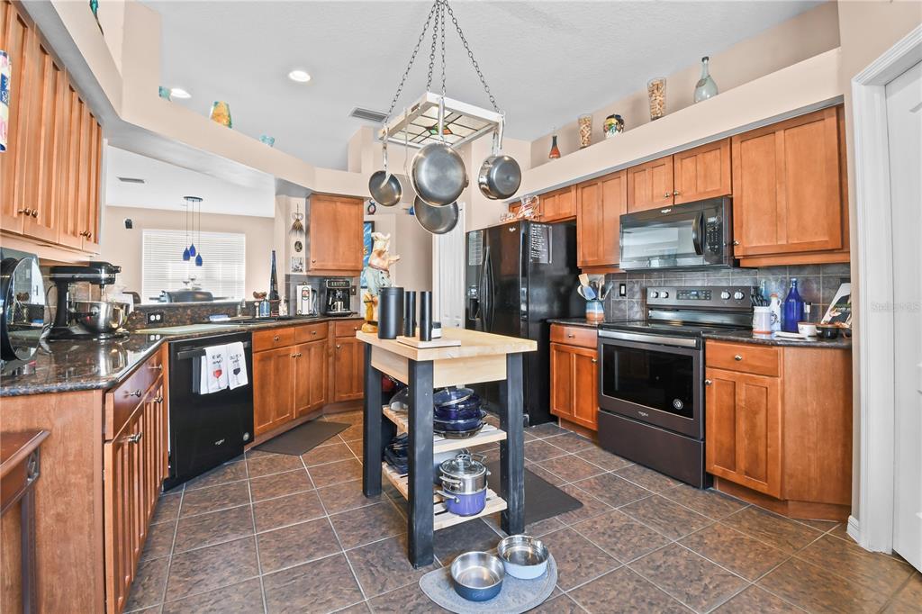 11130 Rodeo Lane Riverview, FL 33579 - Photo 10 of 49 a kitchen with stainless steel appliances granite countertop a sink a stove and a refrigerator
