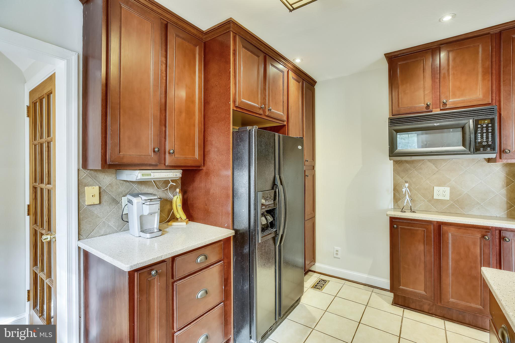 10328 Parkman Road Silver Spring, MD 20903 - Photo 14 of 46 a kitchen with stainless steel appliances granite countertop a refrigerator and a stove top oven