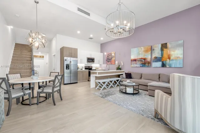 a living room with lots of furniture and chandelier
