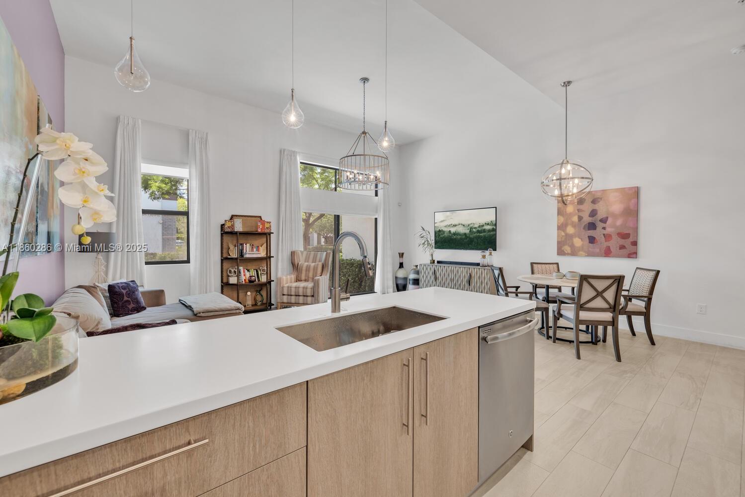 4444 Northwest 8th Court Plantation, FL 33317 - Photo 11 of 40 a kitchen with a sink a counter and chairs
