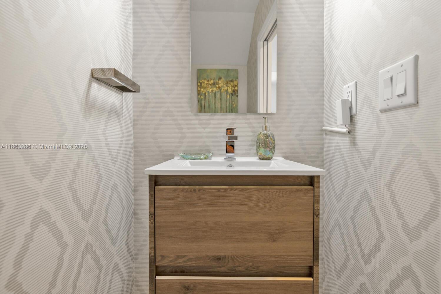 4444 Northwest 8th Court Plantation, FL 33317 - Photo 12 of 40 a bathroom with a granite countertop sink a mirror and shower
