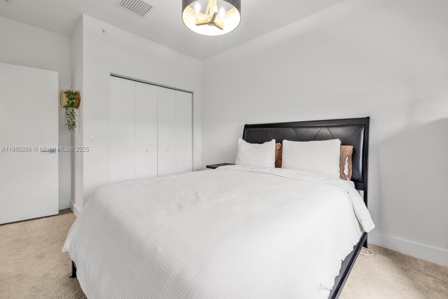 4444 Northwest 8th Court Plantation, FL 33317 - Photo 13 of 40 a bedroom with a bed and a night stand