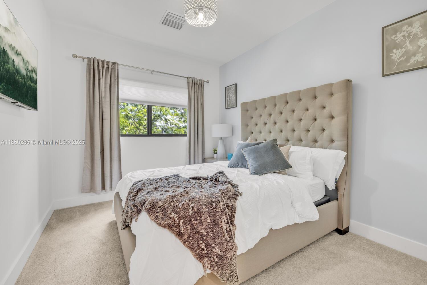 4444 Northwest 8th Court Plantation, FL 33317 - Photo 14 of 40 a bedroom with a bed and a window