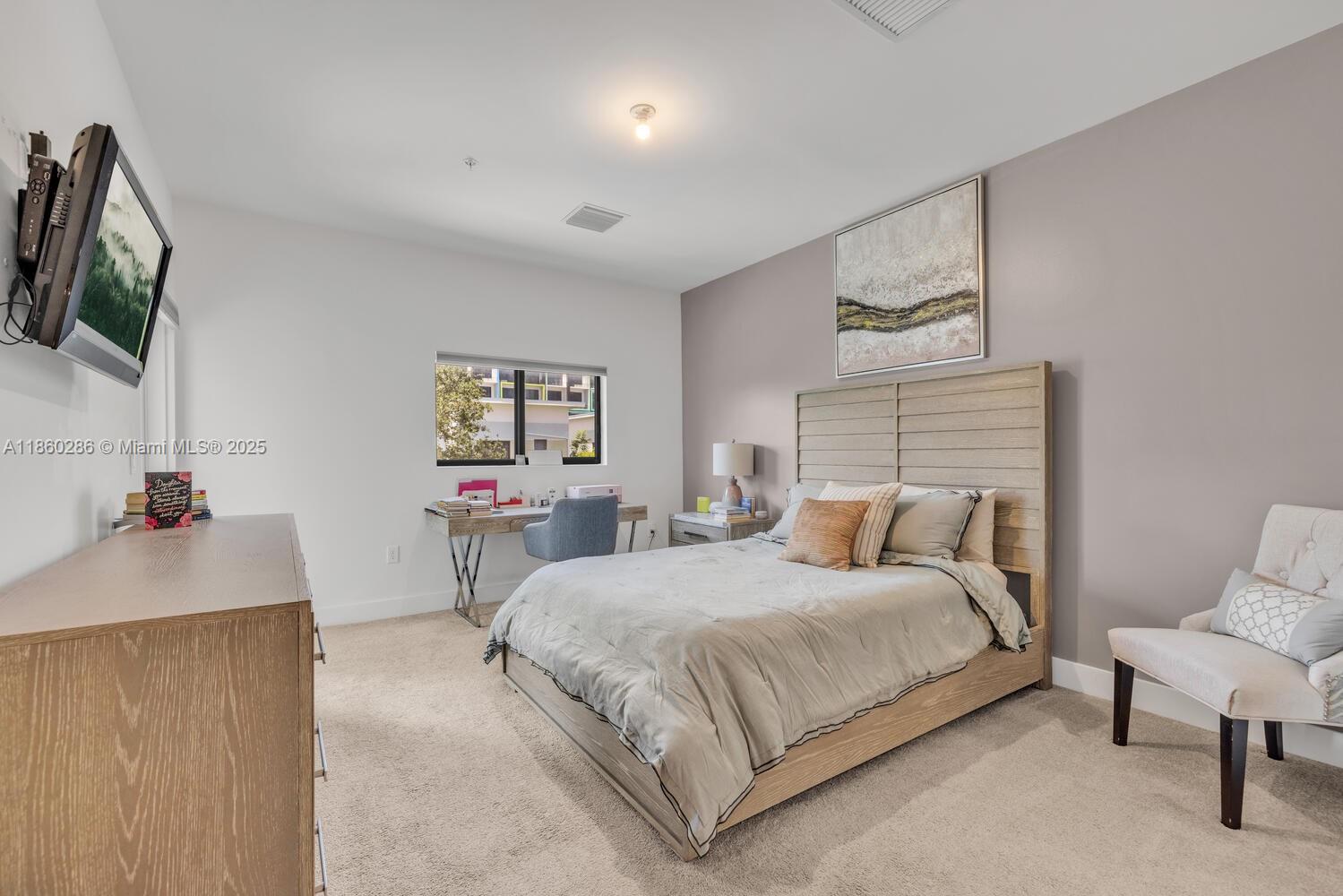 4444 Northwest 8th Court Plantation, FL 33317 - Photo 16 of 40 a bedroom with a bed and a flat screen tv