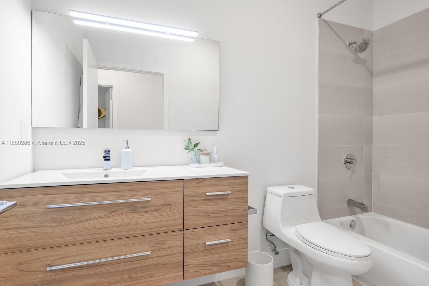 4444 Northwest 8th Court Plantation, FL 33317 - Photo 20 of 40 a bathroom with a sink a toilet and a mirror