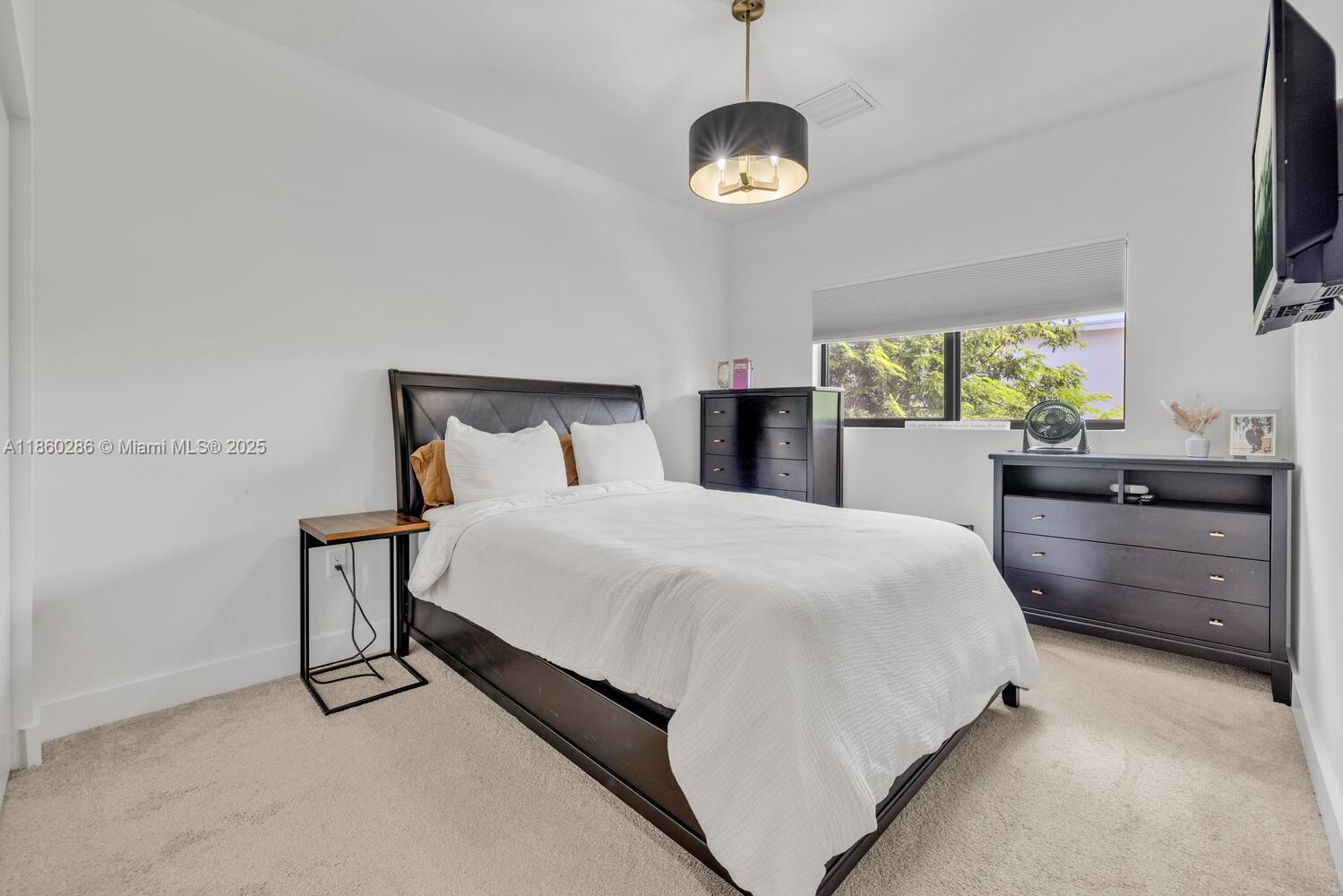 4444 Northwest 8th Court Plantation, FL 33317 - Photo 21 of 40 a bed room with a bed and a television