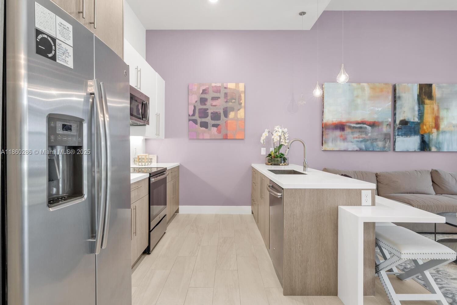 4444 Northwest 8th Court Plantation, FL 33317 - Photo 8 of 40 a kitchen with a refrigerator a stove top oven a sink and dishwasher