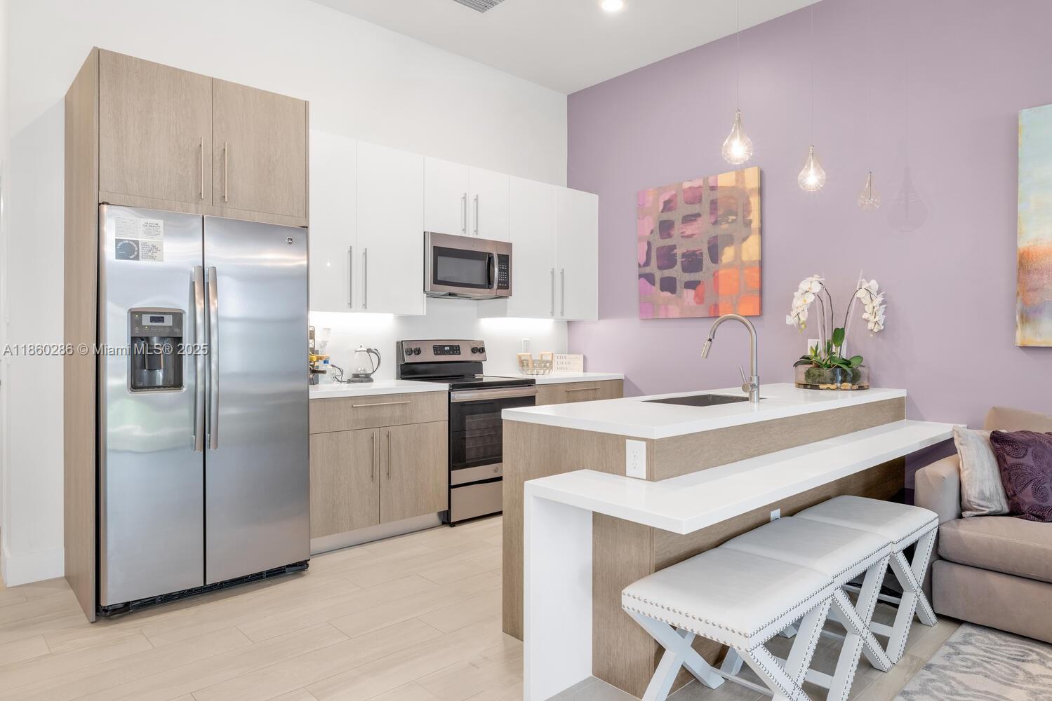 4444 Northwest 8th Court Plantation, FL 33317 - Photo 10 of 40 a kitchen with a refrigerator and a stove