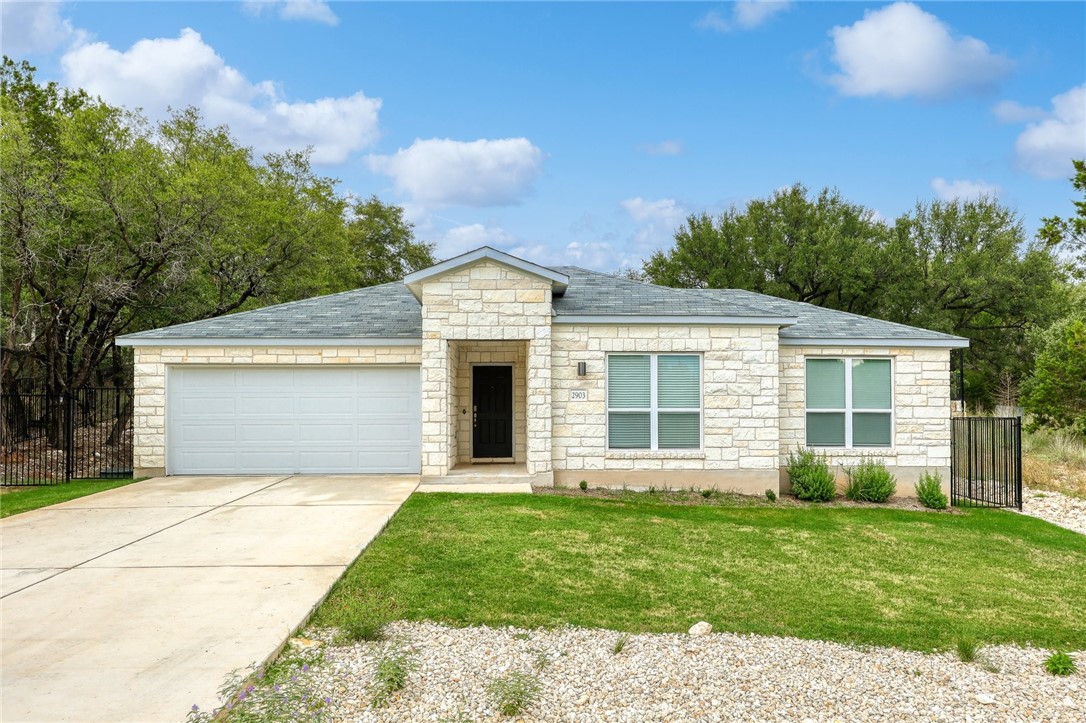 a front view of house with yard and green space