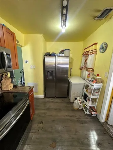 a kitchen with sink refrigerator and stove
